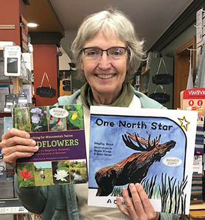 Phyllis Root holding her earlier books
